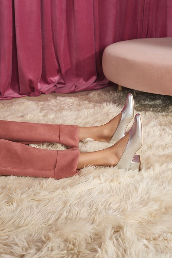 jambes allongées sur tapis rose
